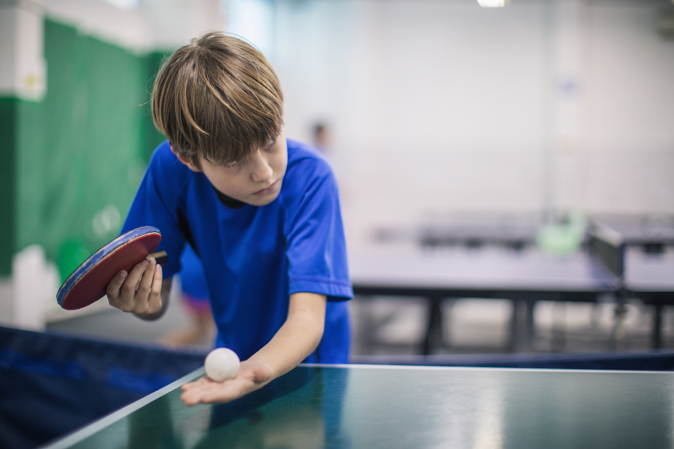 Kid playing table tennis
