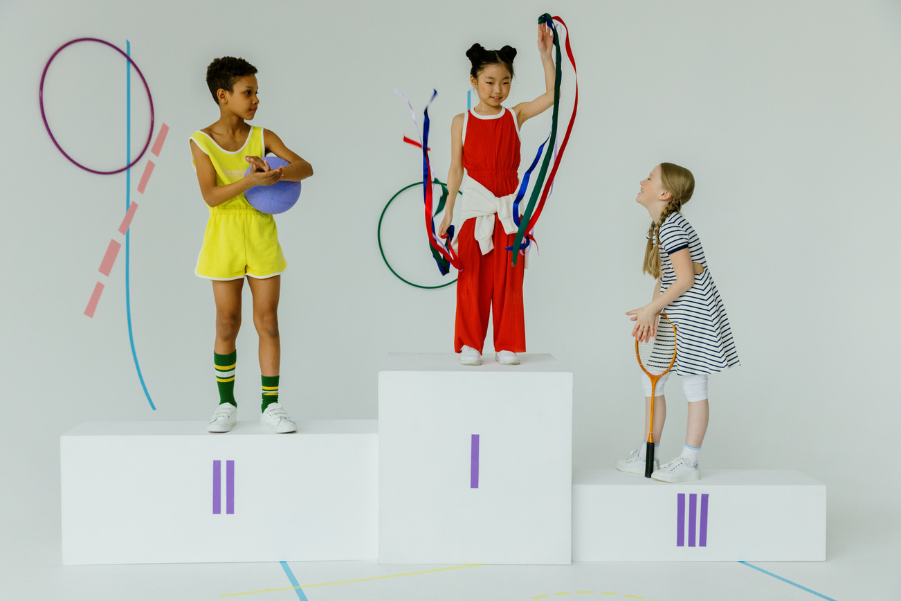 Girls Standing on Sports Podiums